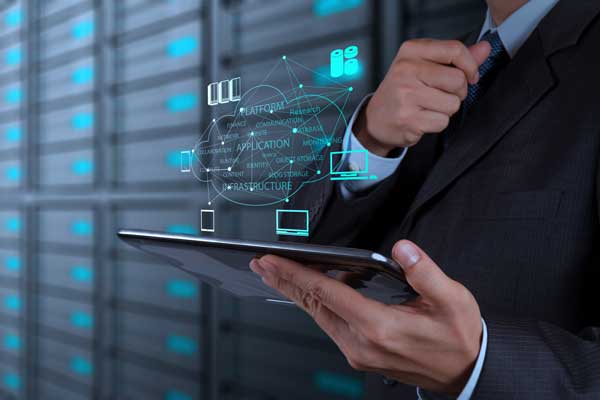 Man with laptop in front of servers